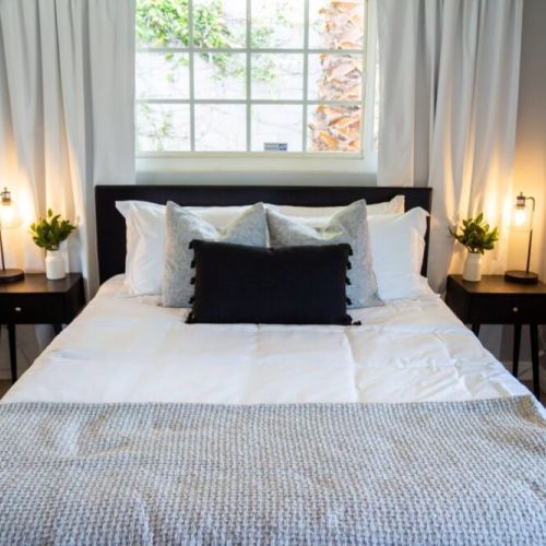 The monochromatic room with artwork of LA Angels of Anaheim and Anaheim Ducks stadiums. Designed in black and white and furnished with a queen memory foam mattress, large dresser for clothes and laptop desk. Also includes a 40 in Roku TV.