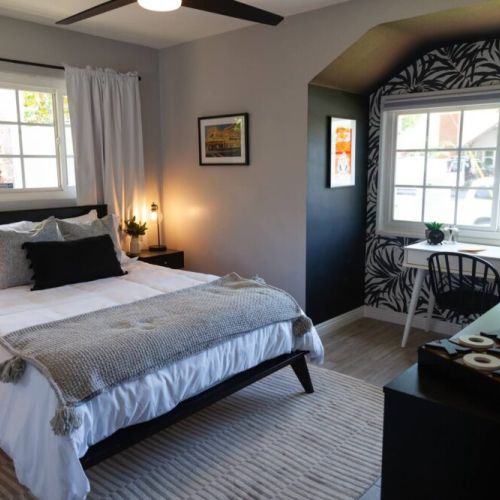 The monochromatic room with artwork of LA Angels of Anaheim and Anaheim Ducks stadiums. Designed in black and white and furnished with a queen memory foam mattress, large dresser for clothes and laptop desk. Also includes a 40 in Roku TV.