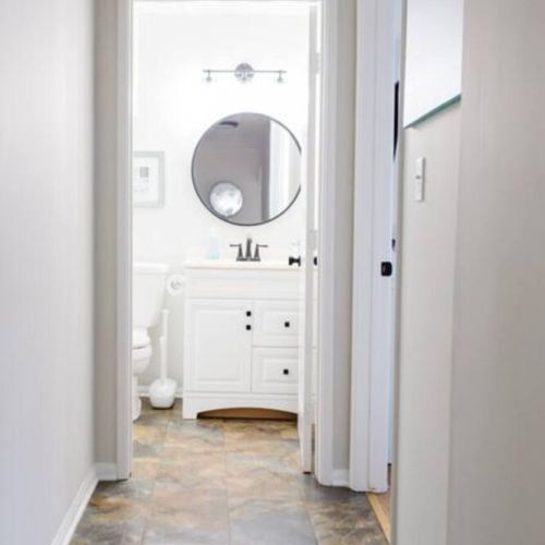Hallway view going towards second bathroom and third bedroom