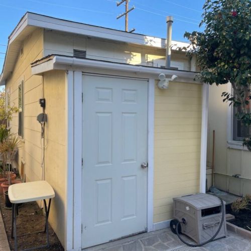 Laundry shed behind unit.