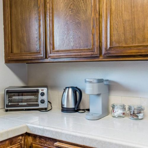 Kitchen equipped with coffee + tea goods, toaster oven, blender, etc.