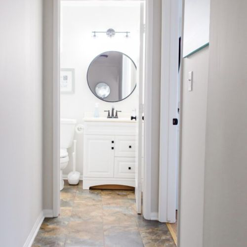 Hallway leading to second shared bathroom