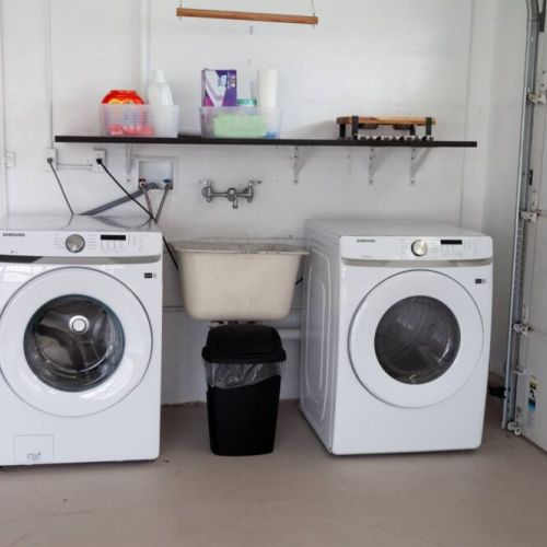 Laundry area with washer and dryer is located in the garage off the kitchen.