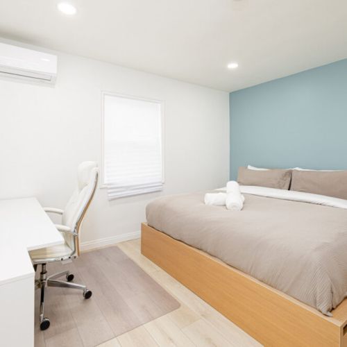 Master bedroom with workdesk and ensuite bathroom