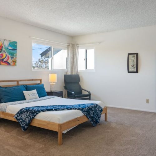 Upstairs bedroom furnished with a queen-sized bed, full-sized closet, and mirror!
