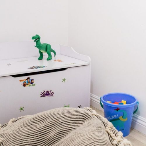 Play area includes a fun Toy Story toy box and soft cushion to sit on