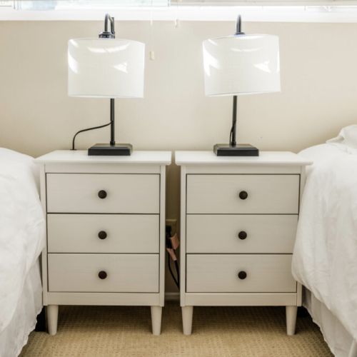Each twin bed has personal nightstands and bedside lighting