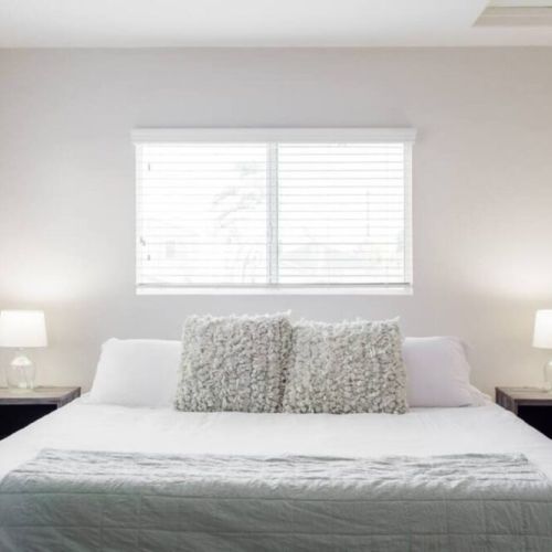 First bedroom. All bedrooms are equipped with king beds and lamps.