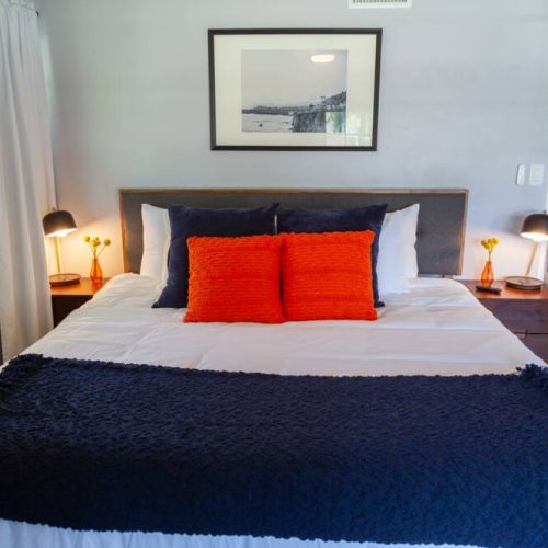 California Poppy Room is full of color. Designed with the California coast in mind and furnished with a King size bed, plenty of natural light or black out curtains. This room has a seating area for reading, plenty of storage and 40 in Roku TV.