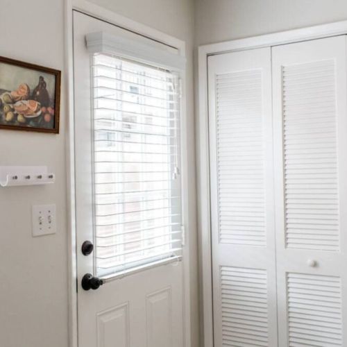 Door leading to the side yard. Washer and dryer located inside the shutter doors.