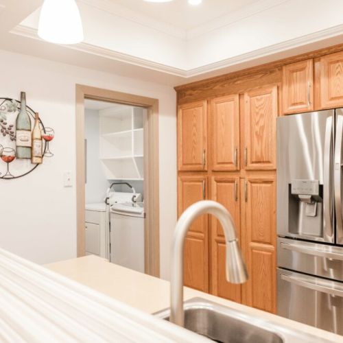 Washer and dryer located adjacent to the kitchen