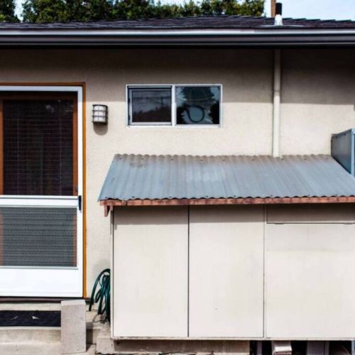 Entrance to second bedroom and  laundry area is attached to the back of the house.