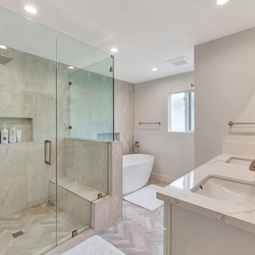 Master bathroom with double sinks and a rain shower