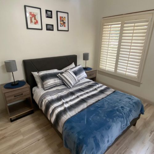 Bedroom furnished with a queen-sized bed and nighstands