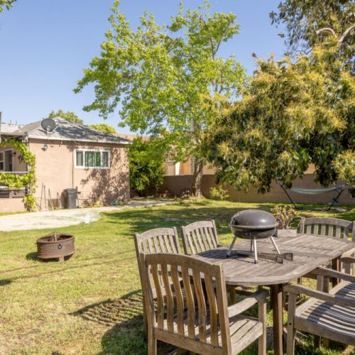 Comfy backyard seating and a charcoal grill to have a little cookout!