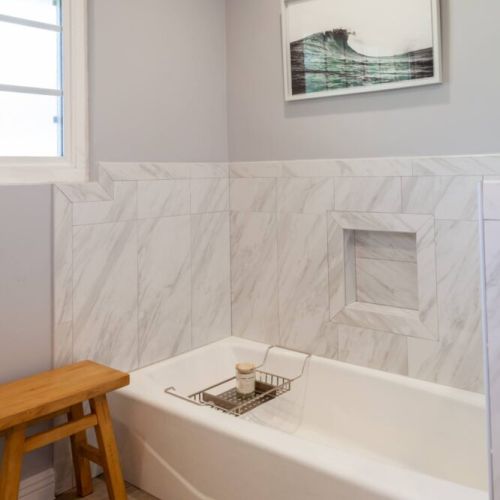 Large master bathroom with bathtub and large walk-in shower.