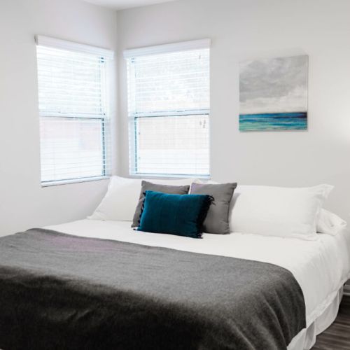 Furnished with a king-sized bed and a large dresser.