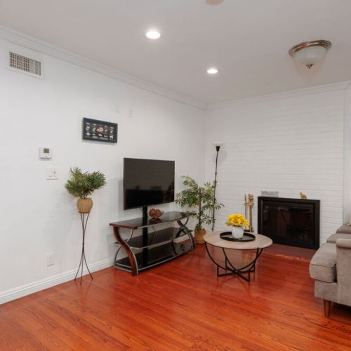 Living room has plenty of seating and a cozy wood-burning fireplace.