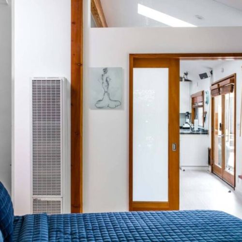 The master bedroom has a sliding frosted door for privacy.