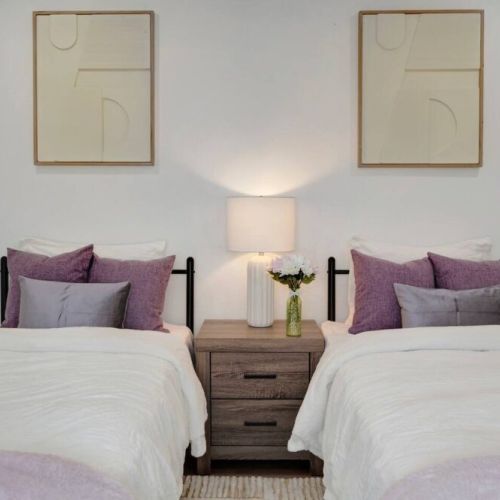 Two twin beds with ample closet space offer a cozy and functional sleeping arrangement, ideal for children or guests.