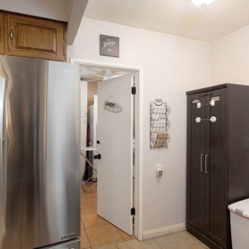 Door from kitchen to shared laundry room