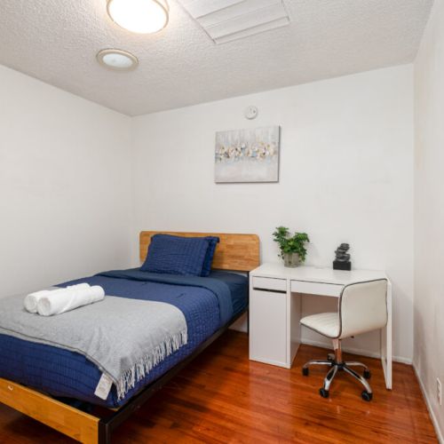 Fourth bedroom furnished with a twin-sized bed and desk