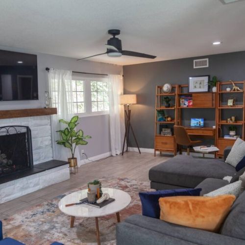 Great living room space to relax and watch a movie on the 65 in Roku TV. Awesome natural light comes through the large windows. Setup your laptop on the desk wall unit and put in a few hours of work.