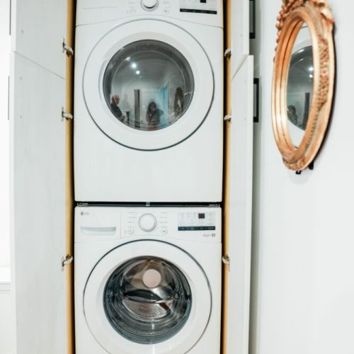 Washer + Dryer. Laundry detergent provided in green tin.