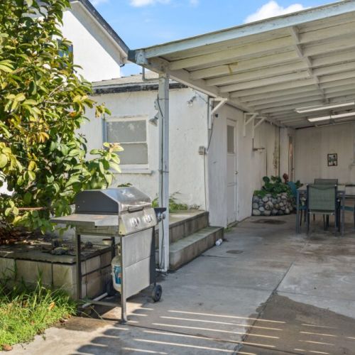 Outdoor patio with seating and a BBQ grill!