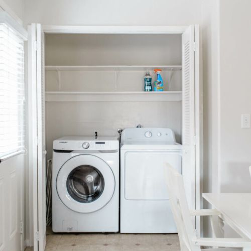 Washer and dryer is located next to the dining area. Laundry detergent also provided.